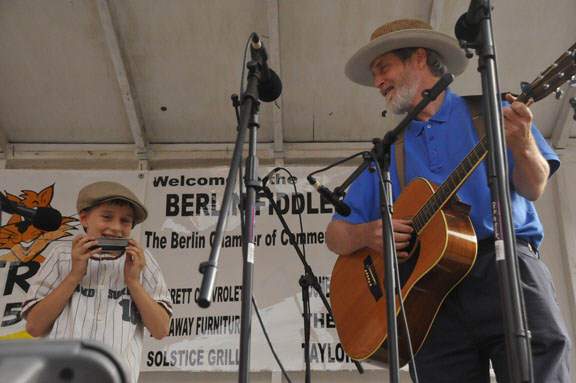 Nathanael playing harmonica with Michael playing guitar.